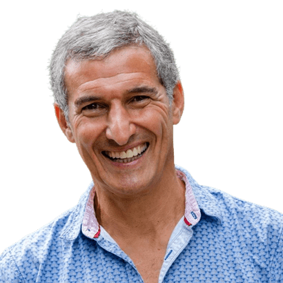 A man with grey hair and a blue shirt.